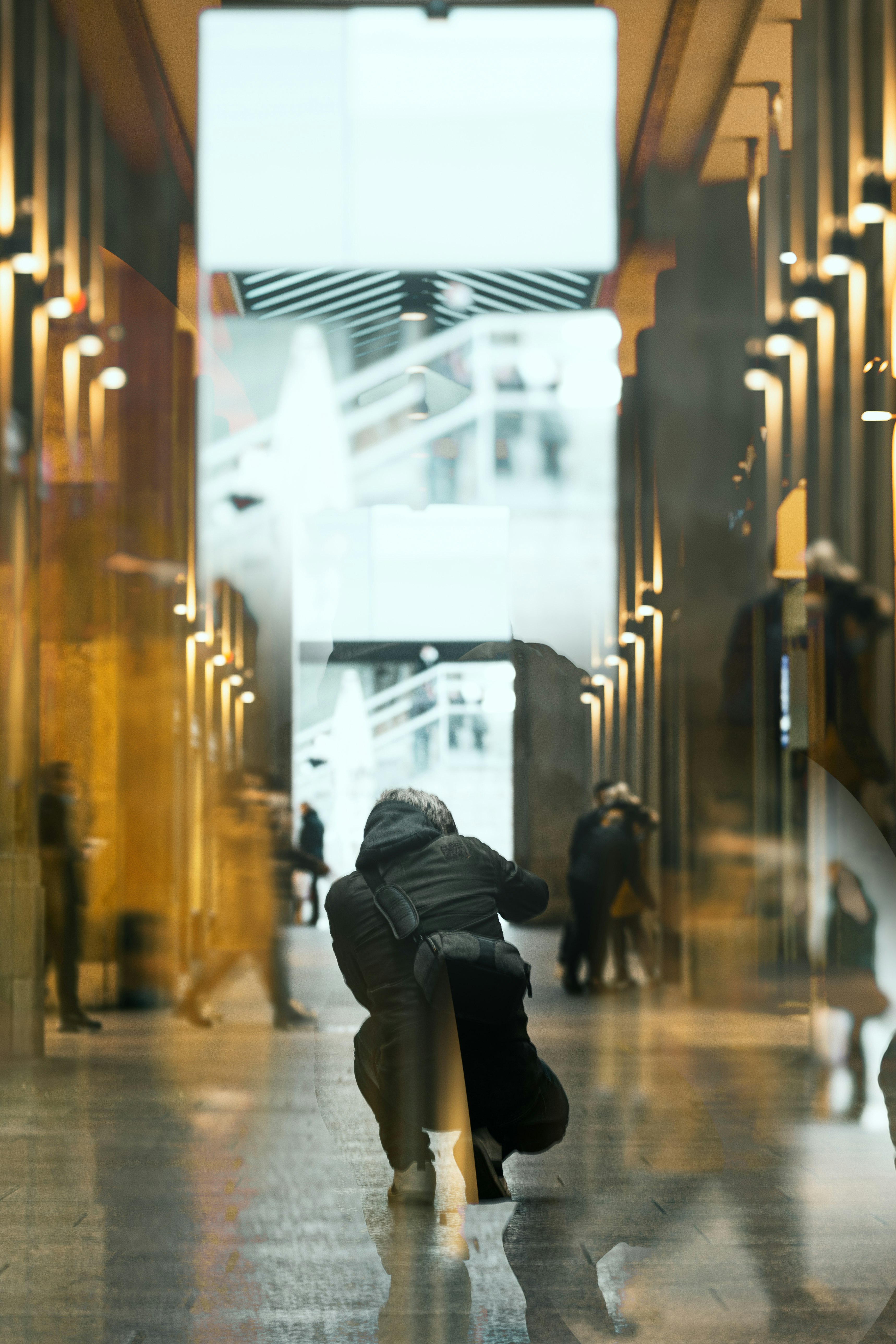 person in black jacket walking on hallway